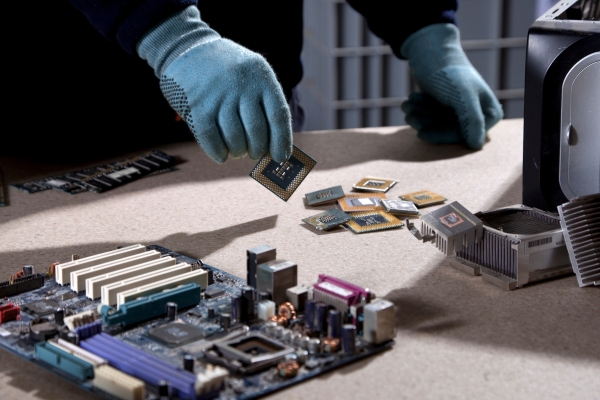 sorting hard drives at e-waste facility
